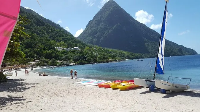 Snorkelers gliding over the reef at Sugar Beach below the Pitons on a st lucia snorkeling land and sea tour, Soufrière